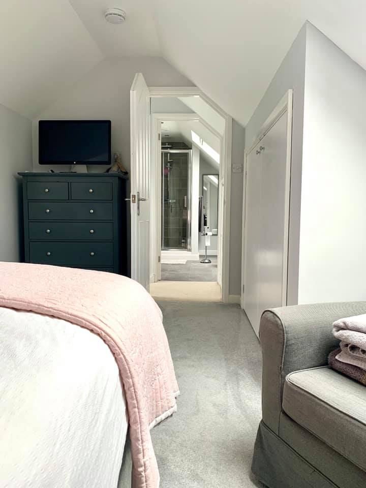 A bright, finished loft bedroom space